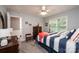 Spacious bedroom with a dresser, striped bedding and large window at 2594 Knoll Ridge Ct, Hickory, NC 28602