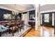 Elegant dining room with hardwood floors, a chandelier, and dark blue walls at 2594 Knoll Ridge Ct, Hickory, NC 28602