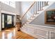 Bright entryway with hardwood floors, a grand staircase, and a large window at 2594 Knoll Ridge Ct, Hickory, NC 28602