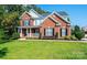 Brick two story house with a front porch and large yard at 2594 Knoll Ridge Ct, Hickory, NC 28602
