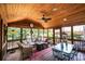 Relaxing screened porch with seating area and dining table, perfect for outdoor entertaining at 2594 Knoll Ridge Ct, Hickory, NC 28602