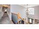 Upstairs hallway showcasing a chandelier and hardwood floors at 2594 Knoll Ridge Ct, Hickory, NC 28602