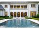 Backyard oasis featuring a pool, fountains, and a covered terrace with outdoor seating at 423 Oakmont Ln, Waxhaw, NC 28173