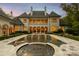 Expansive backyard featuring a luxurious pool with fountain features and an elegant terrace at 423 Oakmont Ln, Waxhaw, NC 28173
