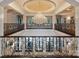 Grand balcony with wrought iron railings, overlooking a chandelier, marble floors, and exterior views at 423 Oakmont Ln, Waxhaw, NC 28173