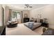 Cozy bedroom featuring soft carpet, accent chair, and a ceiling fan at 423 Oakmont Ln, Waxhaw, NC 28173