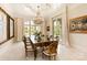 Formal dining room boasts exquisite chandelier, floor-to-ceiling windows, and an ornate wood table at 423 Oakmont Ln, Waxhaw, NC 28173