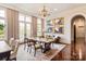 Elegant dining room featuring hardwood floors, coffered ceiling, and large windows at 423 Oakmont Ln, Waxhaw, NC 28173