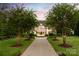 Beautiful home with manicured lawn and pathway leading to the grand entrance at 423 Oakmont Ln, Waxhaw, NC 28173