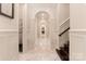 Hallway with archways, elegant molding, and tile floors leads to other rooms in the house at 423 Oakmont Ln, Waxhaw, NC 28173