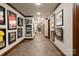 Long hallway featuring tile floors and framed sports memorabilia on the walls at 423 Oakmont Ln, Waxhaw, NC 28173