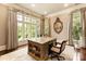Bright home office with a custom desk, large windows, and elegant decor at 423 Oakmont Ln, Waxhaw, NC 28173