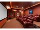 Home theater with plush red seating, projection screen, and ambient lighting at 423 Oakmont Ln, Waxhaw, NC 28173