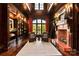 Library featuring a fireplace, custom bookshelves, rich wood finishes, and plush seating at 423 Oakmont Ln, Waxhaw, NC 28173