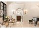 Elegant living room showcasing detailed wall moldings, chandelier, and a view into the kitchen at 423 Oakmont Ln, Waxhaw, NC 28173