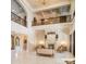 Elegant living room with a soaring ceiling, ornate fireplace, balcony, and marble floors for a luxurious ambiance at 423 Oakmont Ln, Waxhaw, NC 28173