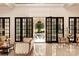 Elegant living room with marble floors and access to the pool, features decorative furniture and dark wood-framed doors at 423 Oakmont Ln, Waxhaw, NC 28173