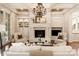 Comfortable living room featuring a fireplace, built-in shelves, and classic neutral furnishings at 423 Oakmont Ln, Waxhaw, NC 28173
