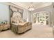 Luxurious main bedroom featuring a chandelier, sitting area, and custom headboard at 423 Oakmont Ln, Waxhaw, NC 28173