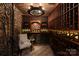Brick wine cellar with custom racks, iron gate, and accent lighting at 423 Oakmont Ln, Waxhaw, NC 28173