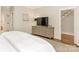 Spacious bedroom with dresser, TV, and access to hallway at 1218 Wareham Ct, Charlotte, NC 28207