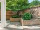 Charming courtyard with brick walls, planters and a tree at 1218 Wareham Ct, Charlotte, NC 28207