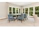 Elegant dining room with wood table and blue velvet chairs at 1218 Wareham Ct, Charlotte, NC 28207