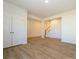 Unfinished basement with hardwood floors, closets, and staircase at 10509 Boudreaux St, Huntersville, NC 28078