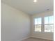 Well-lit bedroom with neutral walls and carpet, plus two windows at 10509 Boudreaux St, Huntersville, NC 28078