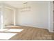 Bright dining room with hardwood floors and modern chandelier at 10509 Boudreaux St, Huntersville, NC 28078
