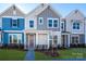 Modern townhome with blue and gray siding, and a purple front door at 10509 Boudreaux St, Huntersville, NC 28078