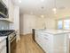 Modern kitchen with white cabinets, stainless steel appliances, and island at 10509 Boudreaux St, Huntersville, NC 28078