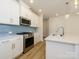 Modern kitchen with white cabinets, stainless steel appliances, and island at 10509 Boudreaux St, Huntersville, NC 28078