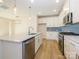 Modern kitchen with white cabinets, stainless steel appliances, and blue herringbone backsplash at 10509 Boudreaux St, Huntersville, NC 28078