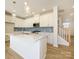 Modern kitchen with white cabinets, herringbone backsplash, and large island at 10509 Boudreaux St, Huntersville, NC 28078