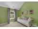 Bright bedroom with a daybed, window, and green walls at 11407 Sidney Crest Ave, Charlotte, NC 28213