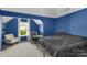 Spacious bedroom with a bed, window, and blue walls at 11407 Sidney Crest Ave, Charlotte, NC 28213