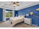 Spacious bedroom with blue walls and ceiling fan at 11407 Sidney Crest Ave, Charlotte, NC 28213