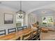 Bright dining room features a large wooden table with seating for eight at 11407 Sidney Crest Ave, Charlotte, NC 28213