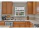 Kitchen features double sink and wood cabinets at 11407 Sidney Crest Ave, Charlotte, NC 28213
