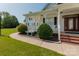 Inviting front porch with brick steps, white columns, and landscaping at 3624 Ramsey Rd, Sharon, SC 29742