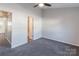Light-filled bedroom featuring neutral walls, soft carpeting, and an attached bathroom at 6427 Saint Bernard Way, Charlotte, NC 28269