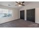 Bright bedroom with a ceiling fan, two closets, and a window allowing for natural light at 6427 Saint Bernard Way, Charlotte, NC 28269