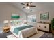 Bright bedroom with a ceiling fan, a large window, and stylish decor and furnishings at 6427 Saint Bernard Way, Charlotte, NC 28269