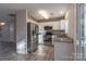 Well-lit kitchen featuring stainless steel appliances, granite countertops, and white cabinetry at 6427 Saint Bernard Way, Charlotte, NC 28269