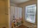 Updated bathroom with a shower/tub combo and floral shower curtain at 2222 19Th Ne Ave, Hickory, NC 28601