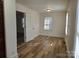 Bedroom with hardwood floors, window and access to another room at 2222 19Th Ne Ave, Hickory, NC 28601