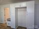 White kitchen with pantry and view into living area at 2222 19Th Ne Ave, Hickory, NC 28601