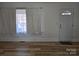 Bright living room featuring hardwood floors, large windows, and a white front door at 2222 19Th Ne Ave, Hickory, NC 28601