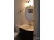 Tight bathroom with vanity and sink, mirror, wall-mounted towel ring, toilet, and decorative painting at 3329 Draper Ave, Charlotte, NC 28205